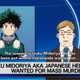A chyron during a news broadcast reveals that Midoriya is wanted for mass murder. A photo of Midoriya appears above it.
